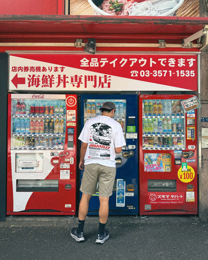 Man wearing Volata Japan Rally t-shirt in front of a Japanese vending machine